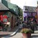 A collection of shops and a seating area full of people